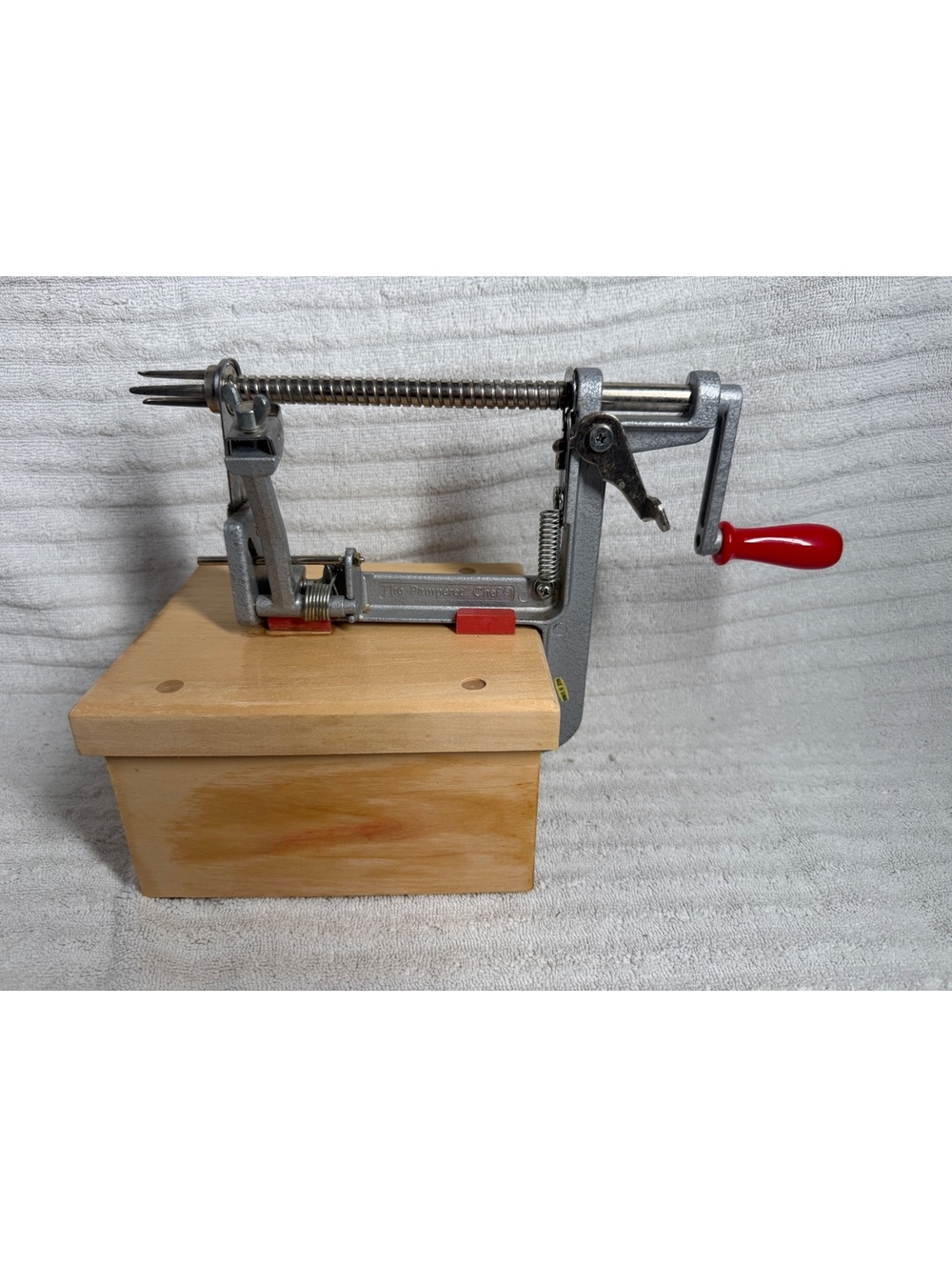 The Pampered Chef Apple Peeler with Wooden Base and Red Handle